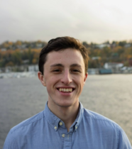 Headshot of Zach in blue shirt