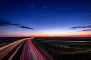 Open road with lights from vehicles