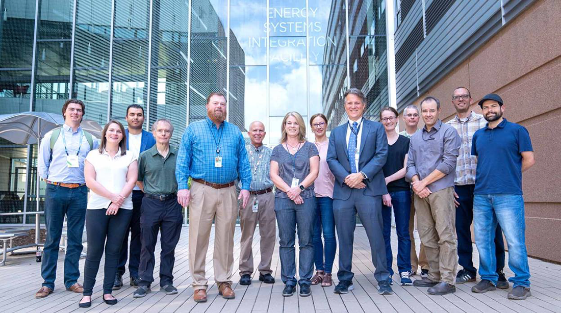 Kevin Lynn (front, third from the right) stands with the Kestrel supercomputer team at the National Renewable Energy Laboratory in Golden, CO.