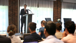 A person giving a presentation behind a podium