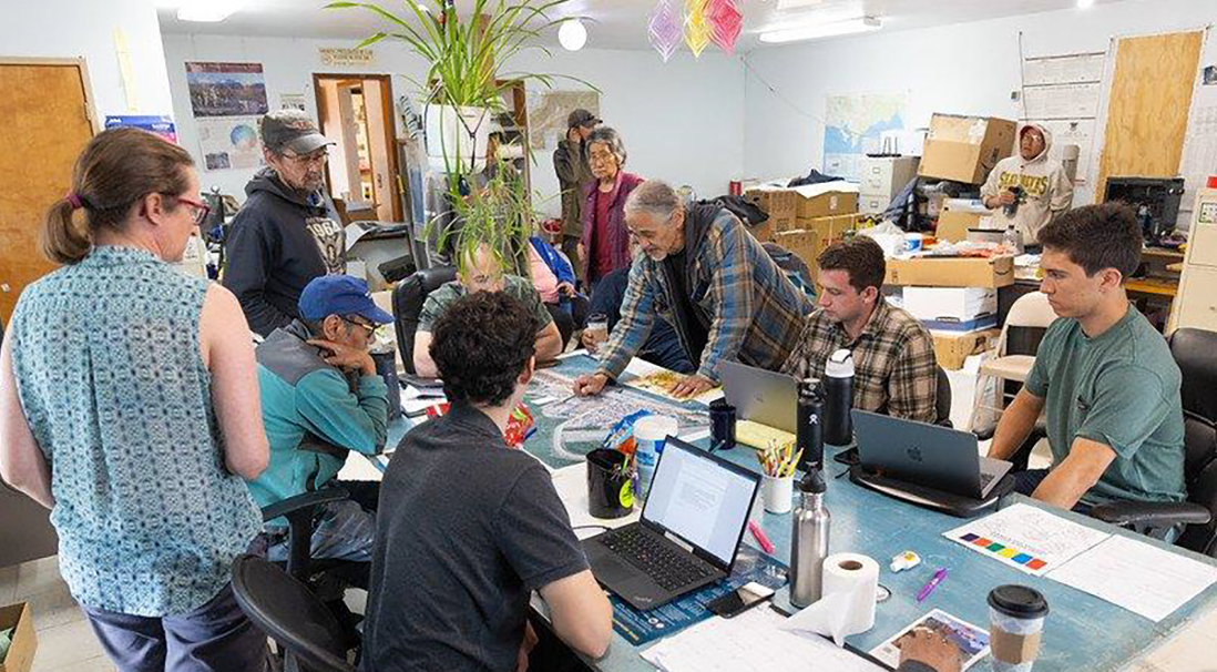 Collegiate team meets with community members to discuss their geothermal project.