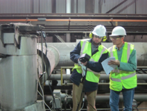 Two workers on a factory site