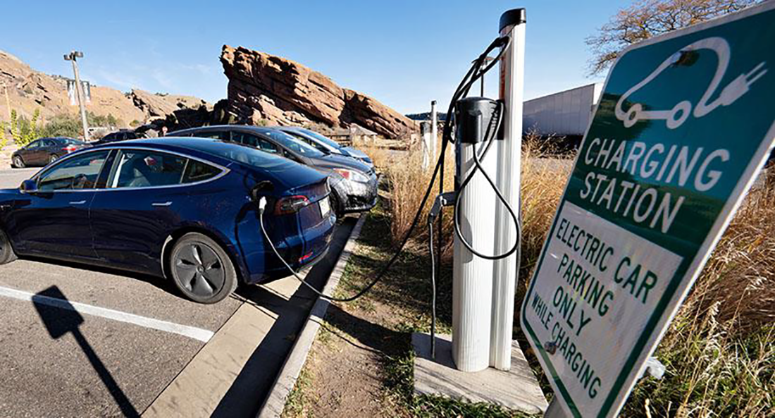 Row of cars charging at EV charging station