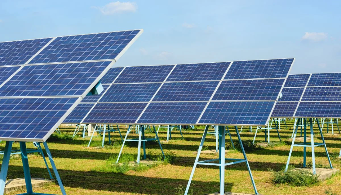 Rows of solar panels and a blue sky