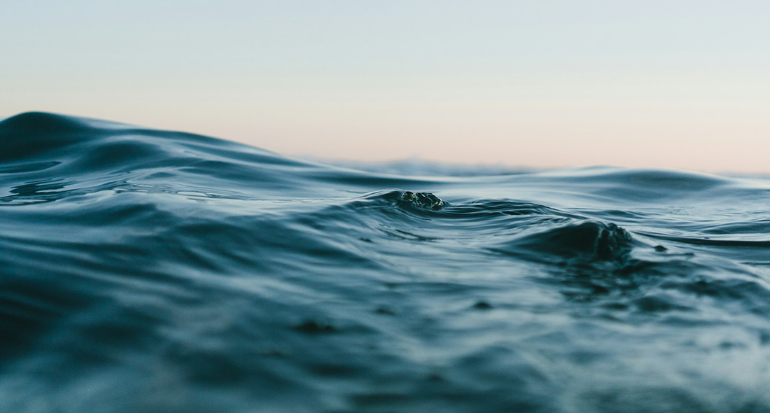 Close up view of waves with sky in background. Photo credit: Matt Hardy on Unsplash