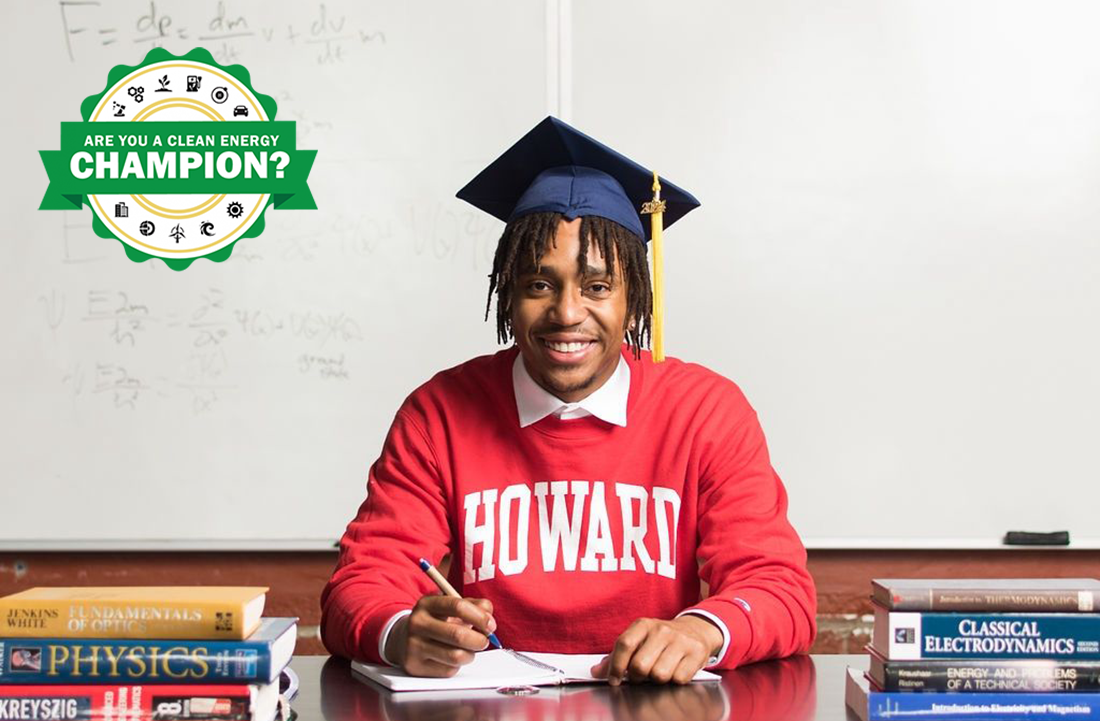 Jon-Edward Stokes in graduation cap at desk