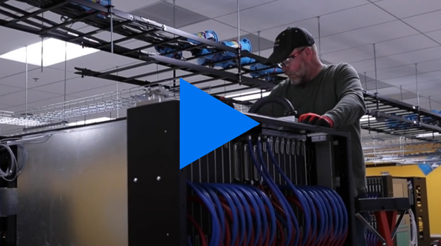 Man working on top of a computer mainframe