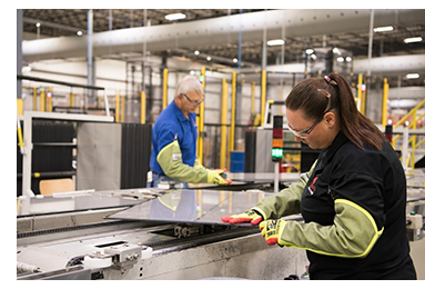 Two workers wearing safety gear in warehouse 