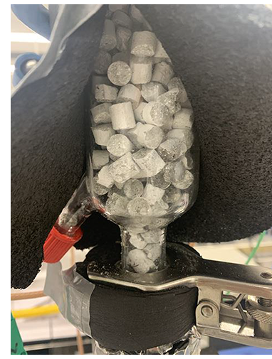 Photo shows cylinders of strontium chloride cement in a laboratory-scale reactor.