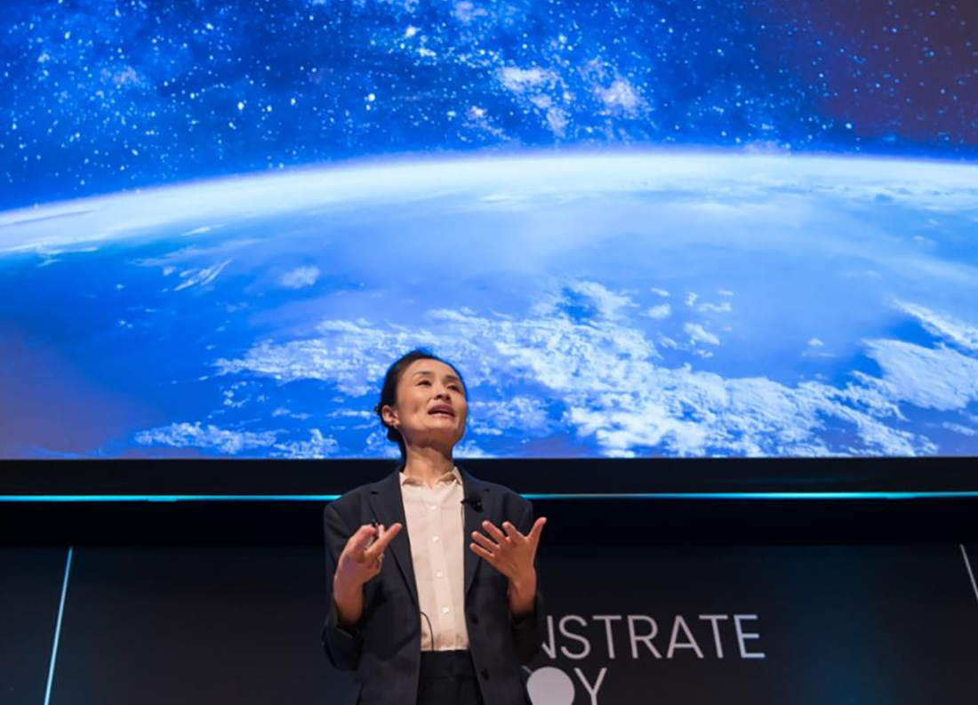 A speaker gives a presentation at a Demonstrate, Deploy, Decarbonize conference.