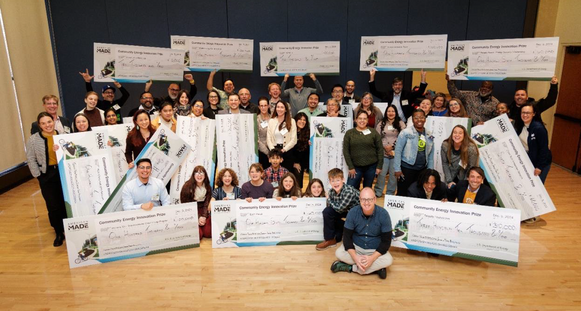 The IMPACT Phase prize winners pose with their checks.