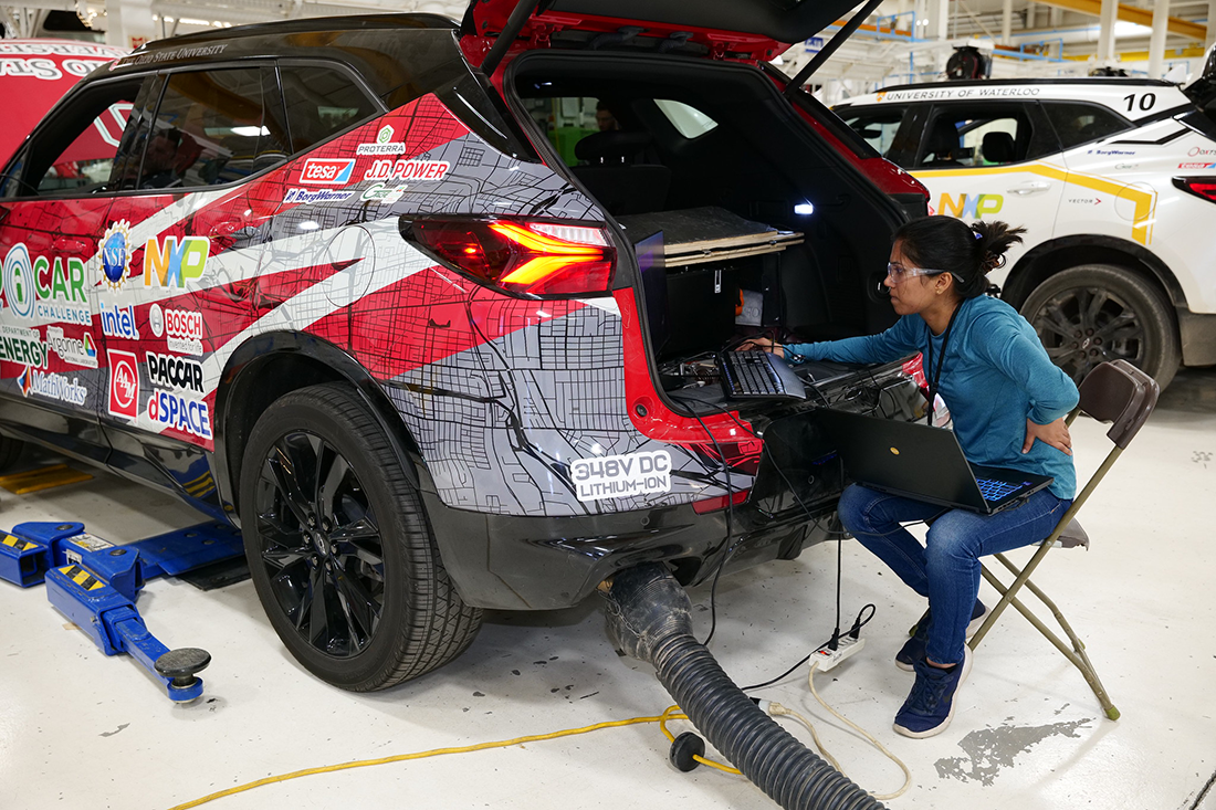 Woman works on vehicle as part of eco-car challenge