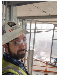 David Castrejón wears a hard hat and safety glasses at a job site.