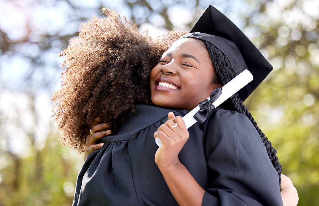 Two graduates hug 