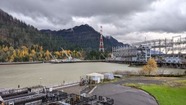 hydropower facility with mountains in the background on a cool, overcast fall day