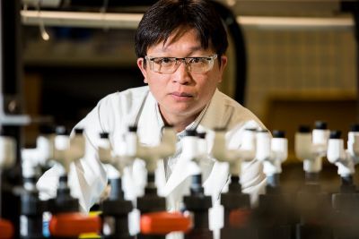 Picture of man standing behind scientific instruments