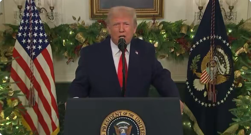 President Trump standing at a lectern addressing the nation. 