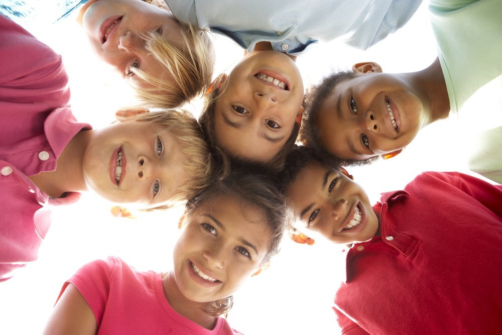 Children smiling down at camera