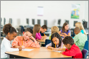 Children sitting at a desk in a classroom