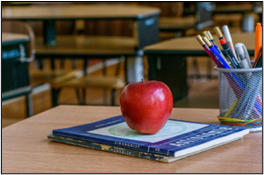 Stack of books with apple on top