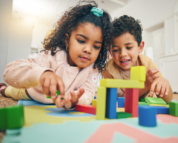 two kids with blocks at home