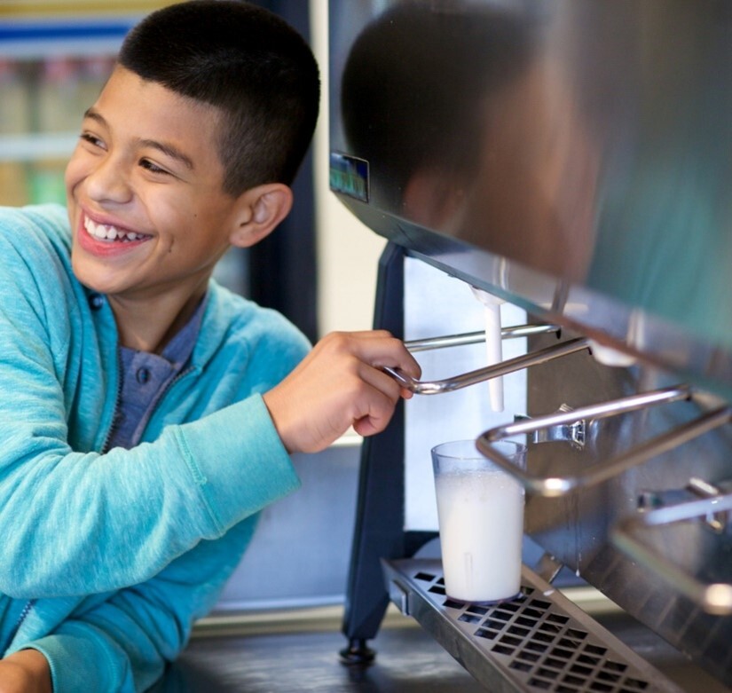 kid pouring milk