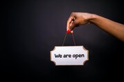 holding an open sign stock photo
