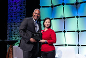 James Greer (left) receives the Acquisition Excellence Award from Christine Harada (right)