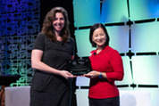 Bonnie Evangelista (left) accepts the Acquisition Excellence Team award on behalf of her team from Christine Harada (right)