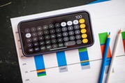 iPhone calculator app open displaying the number 100 in front of a barchart with two colored pencils