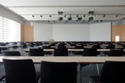 Classroom with empty seats in front of a blank whiteboard