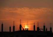 Silhouette of construction project with sunset in background