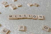 Wooden Blocks on White Surface spelling the word "MISSION"
