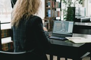 Woman Using a Laptop watching video in a library