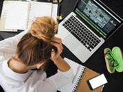 Woman Sitting in Front of Macbook with notebooks studying