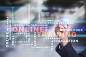 A person writes with a glowing pen as words like "ONLINE TRAINING," "LEARNING," and "EDUCATION" appear in various sizes on a blurred background.