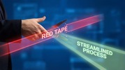Hand cutting a red laser labeled “RED TAPE,” revealing a green beam labeled “STREAMLINED PROCESS” against a digital blue background.