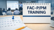 Notebook labeled “FAC-P/PM Training” on a desk with a calendar and laptop, with a blurred instructor-led classroom presentation in the background.