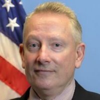 Professional portrait of FAI Director Jeff Birch in front of an American Flag