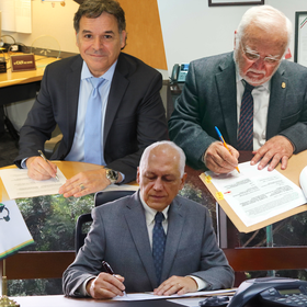 photo  of three gentleman signing a document