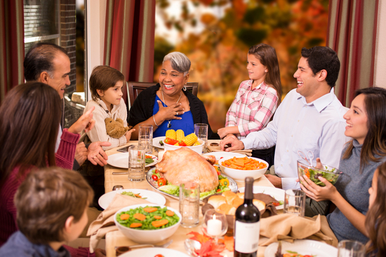 image of people enjoying food while seated at a table