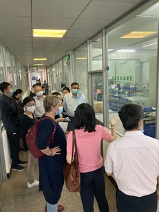 Jennifer Mathern standing with other people looking through a window