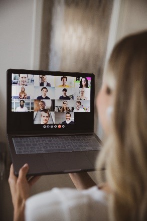 Woman participating in virtual meeting on her laptop