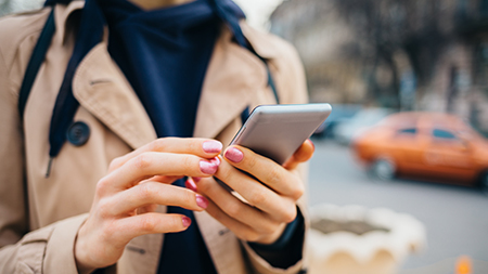 Hands holding a cell phone