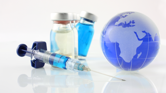 syringe next to a globe