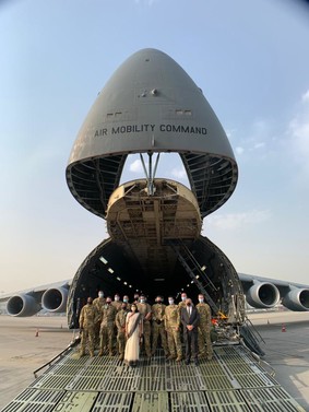 people standing in front of a military aircraft in India 