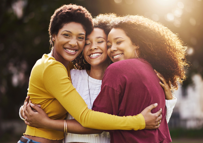 Three black women hugging