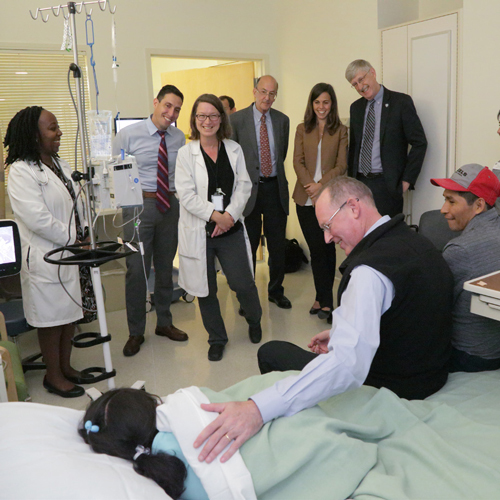Paul Farmer and group of people visiting patient