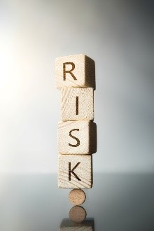 The word risk is spelled out in wooden blocks.