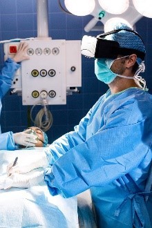 Image of a surgeon wearing a virtual reality headset performing virtual surgery.